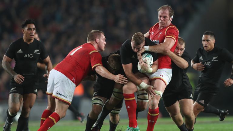 Luke Romano of the All Blacks is tackled by Alan Wyn Jones