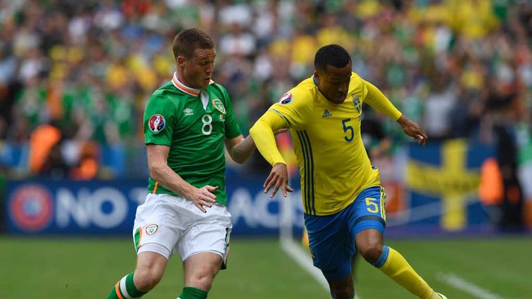 Martin Olsson tussles with Ireland's James McCarthy (L) during the Euro 2016 group E match in Paris
