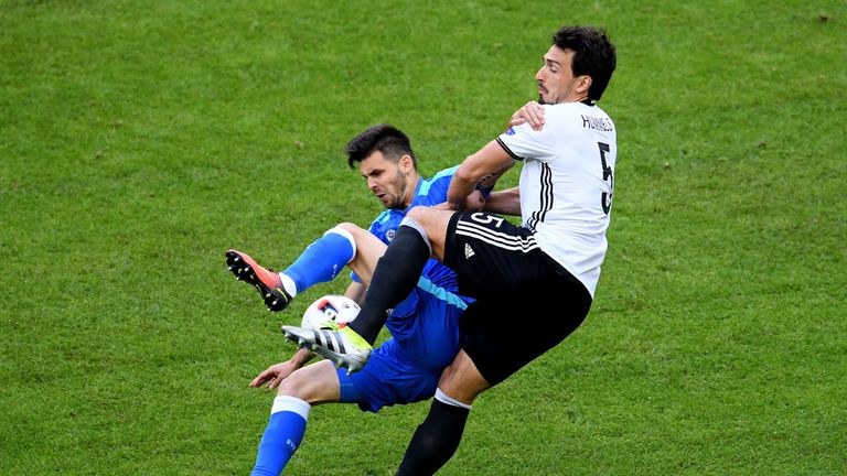 Michal Duris of Slovakia is challenged by Germany's Mats Hummels