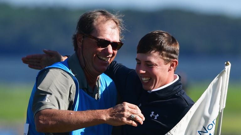 Fitzpatrick celebrates with caddie Lorne Duncan after holing the winning putt