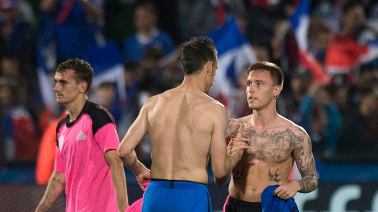 Debutant McKay (right) swaps shirts with France's Laurent Koscielny 