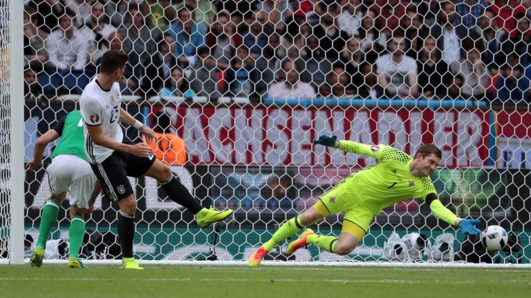 Northern Ireland's goalkeeper Michael McGovern (R) stops a goal attempt by Germany's forward Mario Gomez