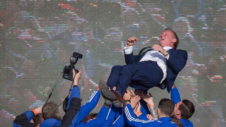 Northern Ireland players lift manager Michael O'Neill in the air as they celebrate with fans in Belfast after the team's success at Euro 2016
