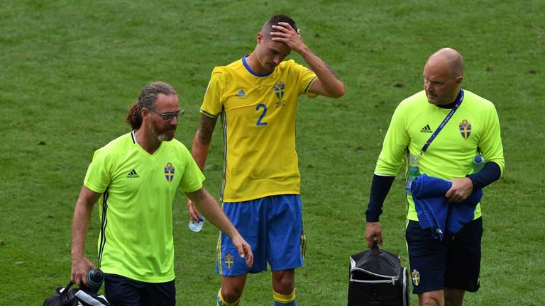 Sweden's defender Mikael Lustig (C) leaves the pitch after being injured during the Euro 2016 group E football match between Ireland and Sweden