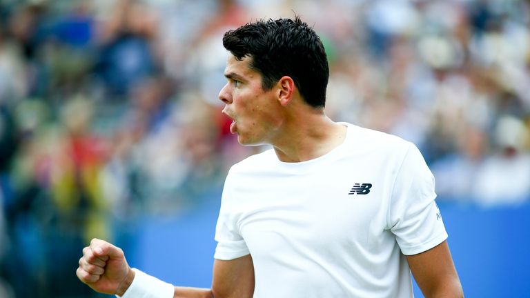 Milos Raonic celebrates winning the first set 