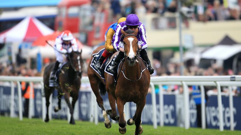 Minding ridden by Ryan Moore on the way to winning The Investec Oaks on Ladies Day