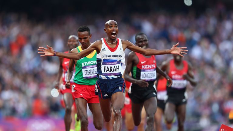 LONDON, ENGLAND - AUGUST 11:  Mohamed Farah of Great Britain celebrates as he crosses the finish line to win gold ahead of Dejen Gebremeskel of Ethiopia an