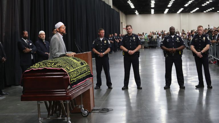 Police stand guard during an Islamic prayer service for Muhammad Ali in Kentucky on Thursday