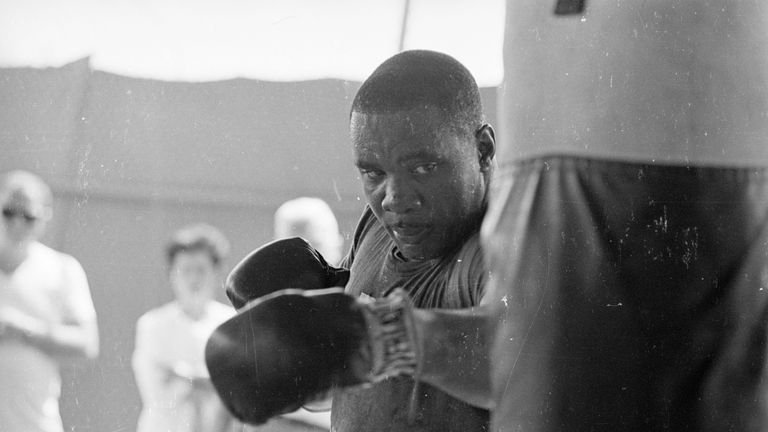 Sonny Liston pounds the heavy bag ahead of facing Ali