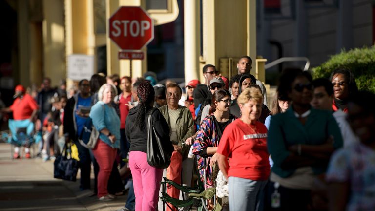 People wait in line for tickets to a memorial service outside the KFC Yum! Center for boxing legend Muhammad Ali 