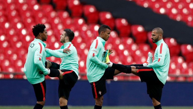Nani (second right) and midfielder Ricardo Quaresma (right) stretch during a training session at Wembley on Wednesday