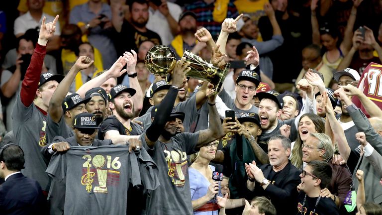 Cleveland's Cavaliers celebrate with the Larry O'Brien Championship Trophy after defeating Golden State Warriors in the deciding seventh game