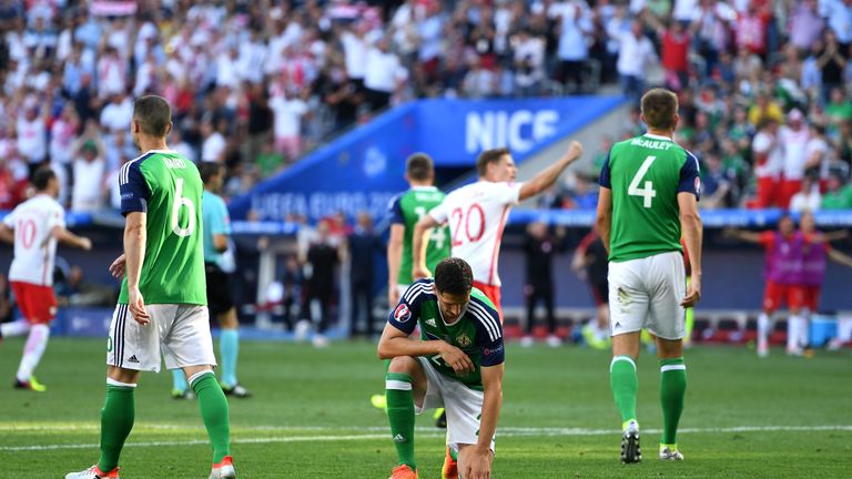 NICE, FRANCE - JUNE 12:  Craig Cathcart (C) of Northern Ireland shows his dejection after Poland's first goal during the UEFA EURO 2016 Group C match betwe