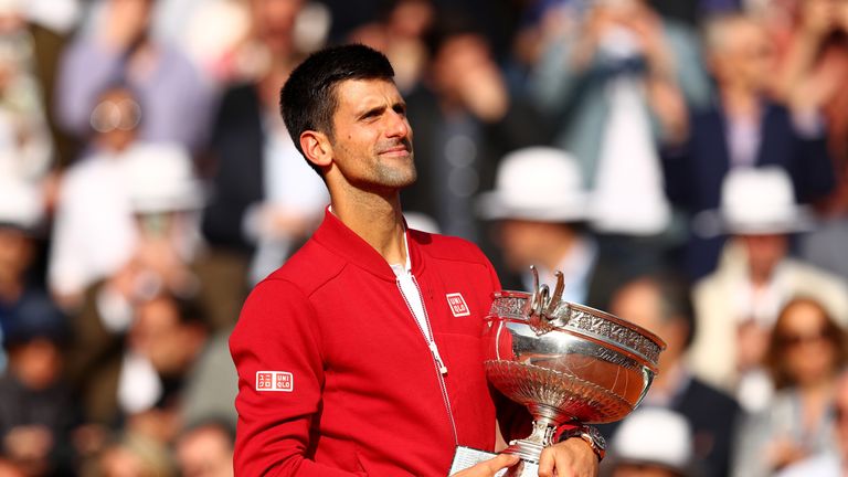 Champion Novak Djokovic of Serbia celebrates with the trophy following his victory in the Men's Singles final match against Andy Murray at the French Open