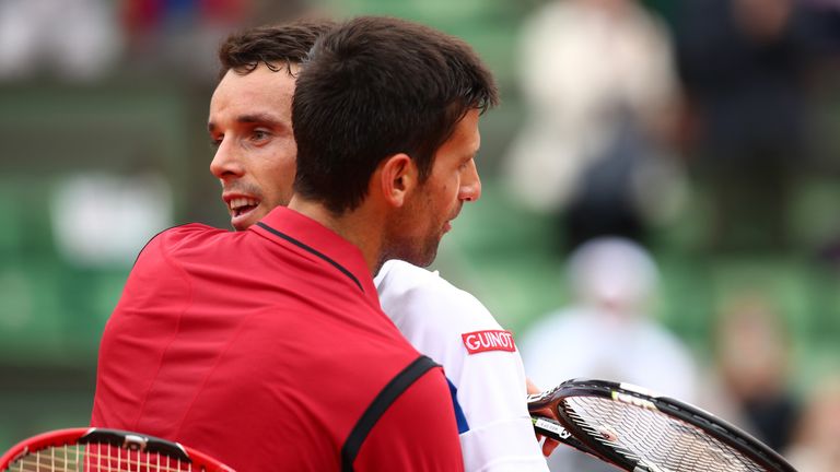 Novak Djokovic hugs Roberto Bautista Agut following his fourth-round victory 