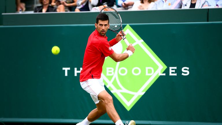 STOKE POGES, ENGLAND - JUNE 22:  Novak Djokovic of Serbia plays a backhand during his match against David Goffin of Belgium during day two of The Boodles T