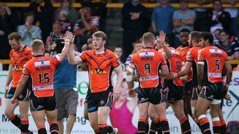 Castleford's Paddy Flynn (third left) is congratulated by Paul McShane (15) on scoring a try.