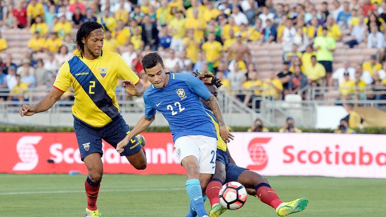 PASADENA, CA - JUNE 4: Philippe Coutinho #22 of Brazil takes a shot on goal against Juan Carlos Paredes #4 and Arturo Mina #2 of Ecuador during the first h