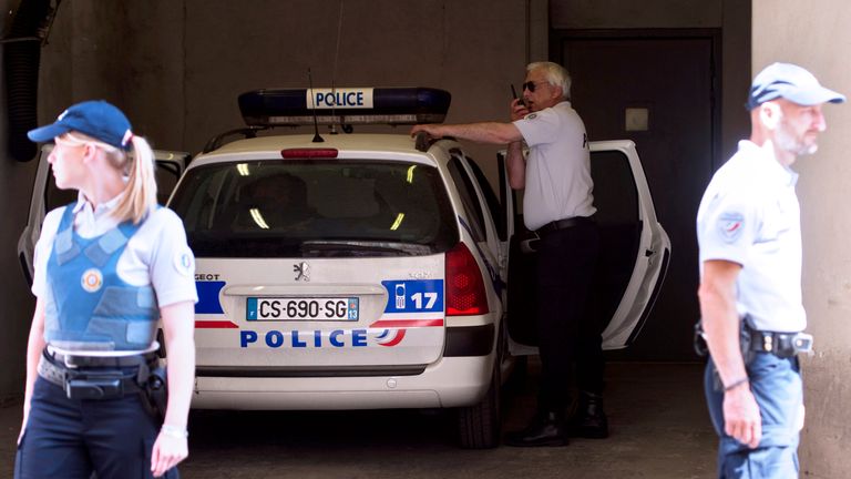 An alleged football supporter arrives with policemen on June 13, 2016 at the courthouse of Marseille, southern France, following clashes during Euro 2016