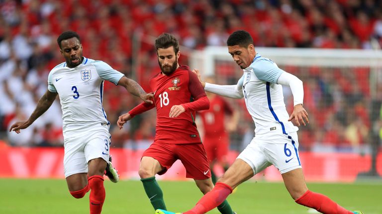 England's Danny Rose and Chris Smalling (right) battle for the ball with Portugal's Rafa Silva
