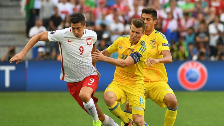 Poland's forward Robert Lewandowski (L) vies with Ukraine's midfielder Ruslan Rotan