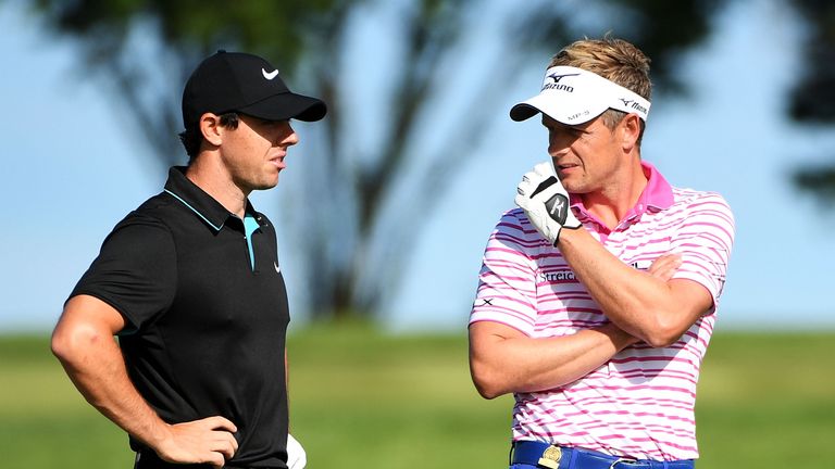 Rory McIlroy of Northern Ireland talks to Luke Donald of England during a practice round prior to the US Open at Oakmont Country Club