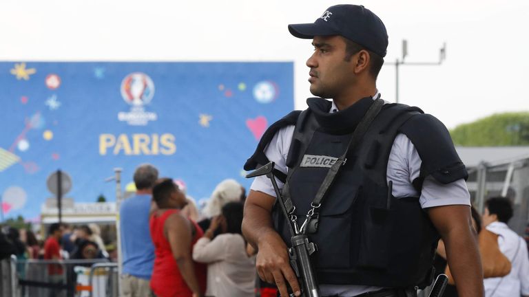 French policeman patrols at the fan zone near the Eiffel Tower ahead of the UEFA 2016 European Championship in Paris