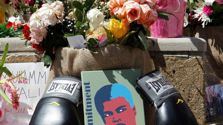 Fans of Muhammad Ali leave pictures and personal mementos as they pay their respects at the Ali Center in Louisville.