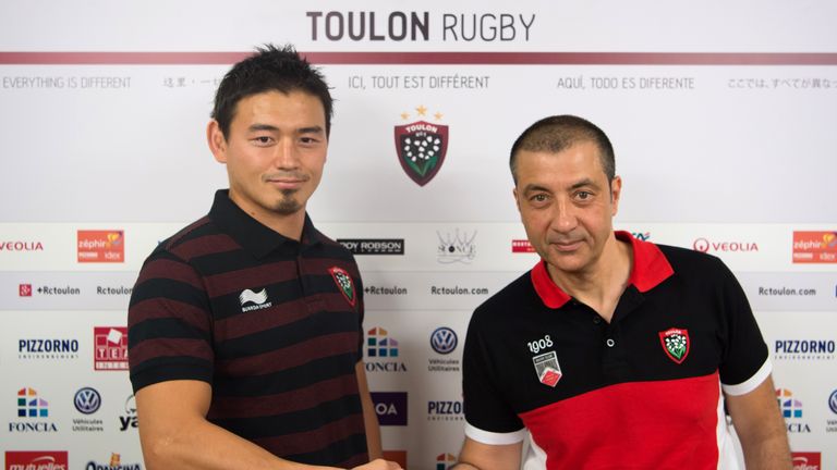 RC Toulon president Mourad Boudjellal (R) shakes hands with Japan full-back Ayumu Goromaru