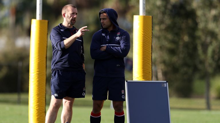 Ben Te'o (R) looks on with team doctor Nigel Jones, the England team doctor after missing the session due to an injury du