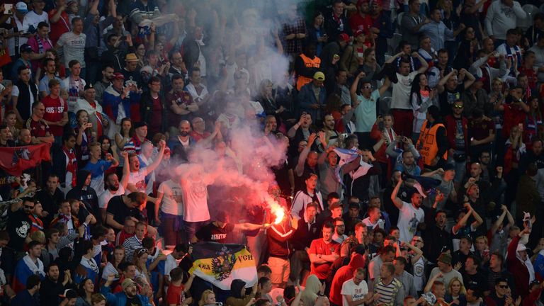 Russia supporters hold a flare during the Euro 2016 group B football match between Russia and Slovakia