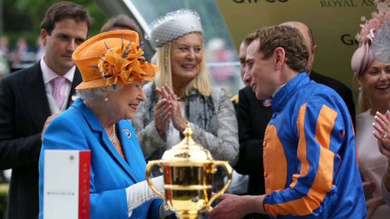 Queen Elizabeth II presents the Gold Cup to winning jockey Ryan Moore