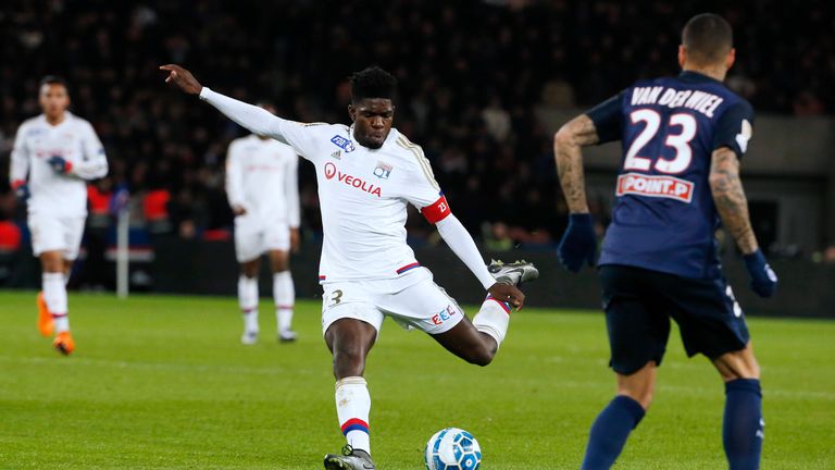 Lyon's French Cameroonian defender Samuel Umtiti (L) shoots the ball during the French League Cup quarter final football match between Paris Saint-Germain 