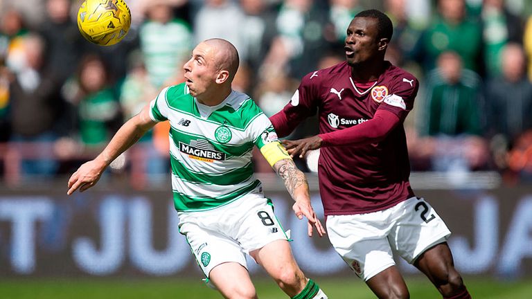 Celtic skipper Scott Brown holds off a challenge in a game against Hearts