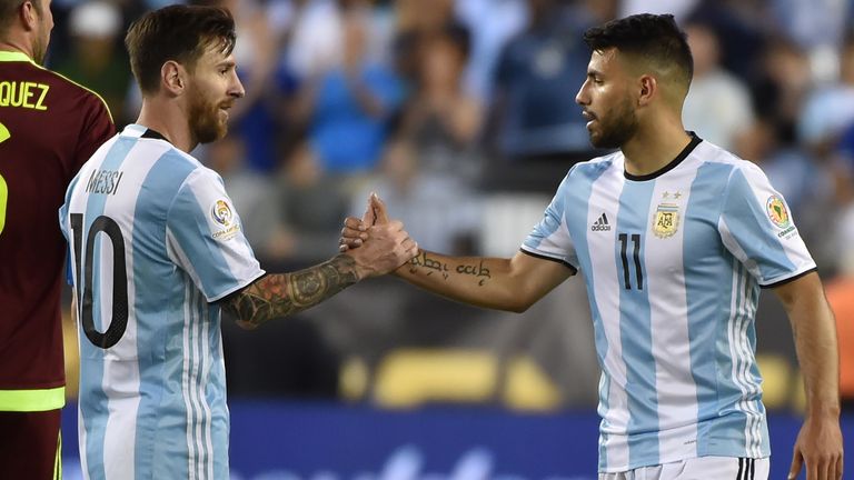 Argentina's Lionel Messi (L) greets Argentina's Sergio Aguero 