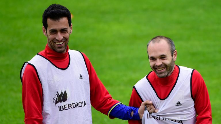 Spain's midfielders Sergio Busquets (l) and Andres Iniesta (r) share a joke