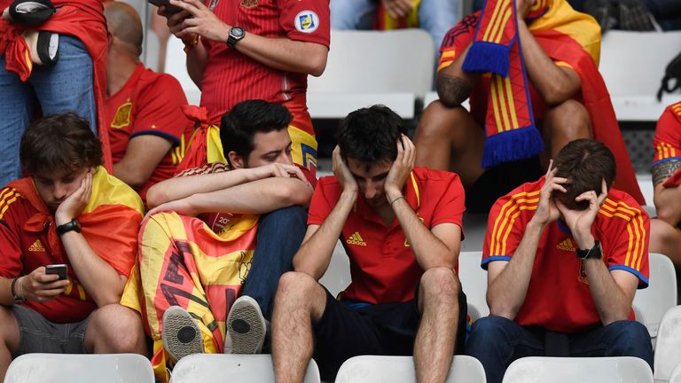 Dejected Spain supporters remain in their seats after seeing their side ousted from Euro 2016 by Italy