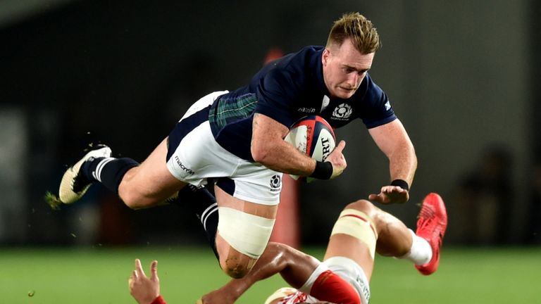 Scotland's Stuart Hogg (top) falls on Japan's Hendrik Tui (bottom) during their rugby union friendly match at Ajinomoto Stadium in Tokyo on June 25, 2016. 