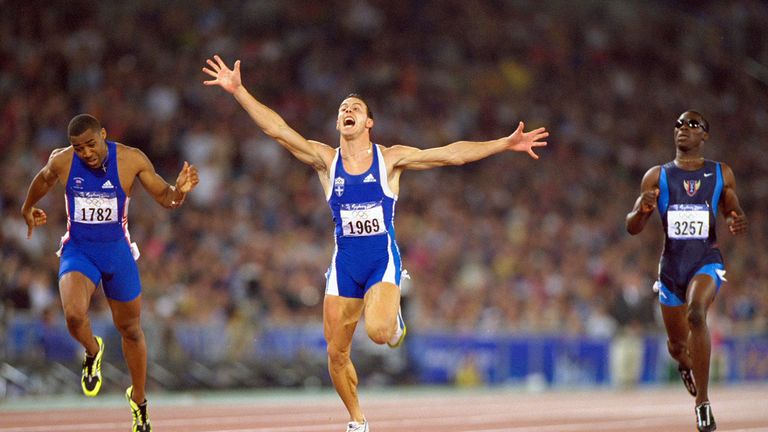 Konstantinos Kenteris of Greece crosses the line to win gold and Darren Campbell of Great Britain (left) wins Silver in 200m final in Sydney