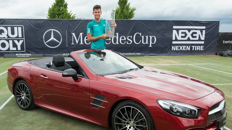 Austria's Dominic Thiem poses inside the winner's prize, a Mercedes-Benz SL 500, during the victory ceremony
