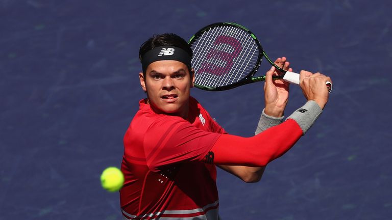 Milos Raonic plays a backhand in his match against Inigo Cervantes during day six of the BNP Paribas Open 