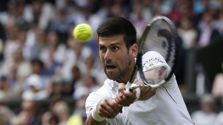 Novak Djokovic returns against Britain's James Ward during 2016 Wimbledon Championship