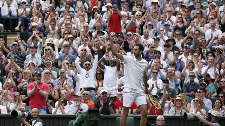 James Ward celebrates winning a game in the second set against Novak Djokovic