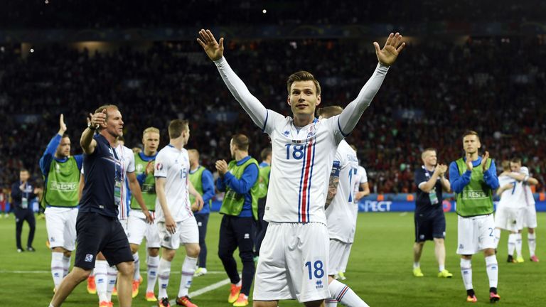 Iceland's midfielder Theodor Bjarnason (C) and his teammates celebrate after a 1-1 draw with Portugal