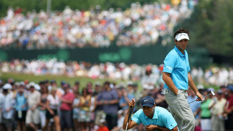 OAKMONT, PA - JUNE 16:  Tiger Woods lines up a putt as Nick Dougherty of England walks behind him during the third round of the 107th U.S. Open Championshi