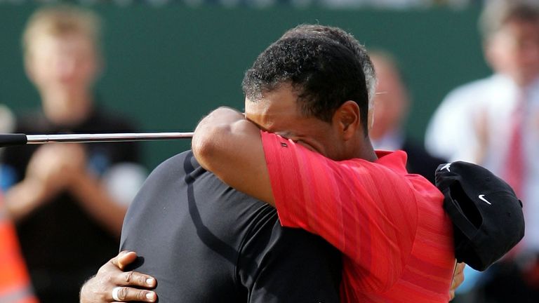 An emotional Tiger Woods embraces his caddy Steve Williams 