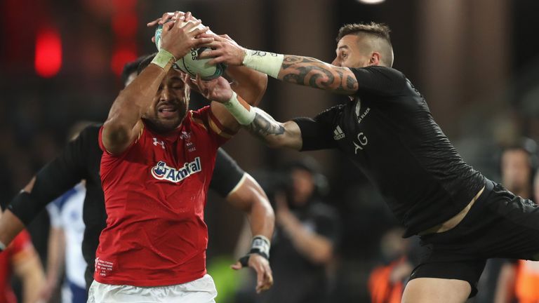 Taulupe Faletau of Wales is tackled by TJ Perenara 