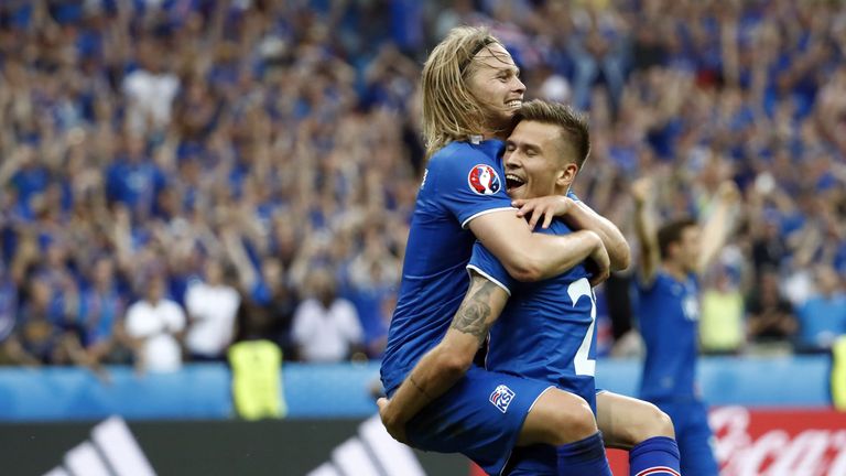 Iceland's midfielder Arnor Ingvi Traustason celebrates scoring the team's second goal with teammate Iceland's midfielder Birkir Bjarnason (top)