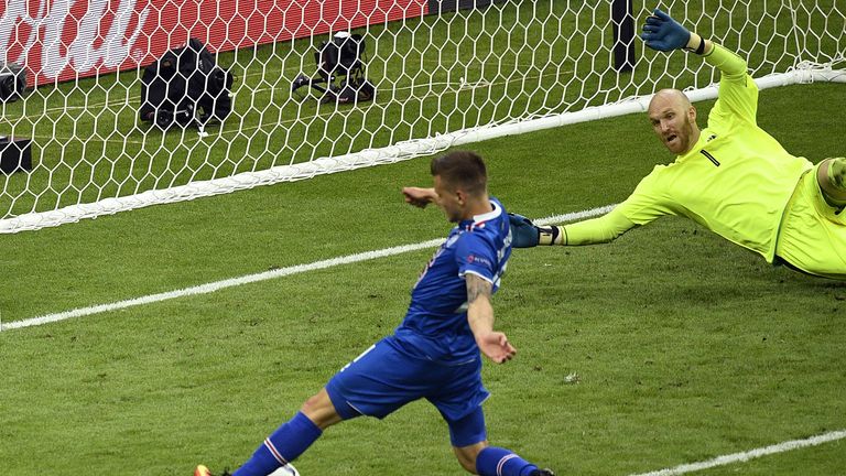 Traustason (L) scores against Austria's goalkeeper in the minute