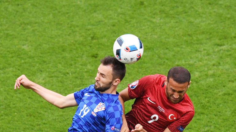 PARIS, FRANCE - JUNE 12: Milan Badelj of Croatia and Cenk Tosun of Turkey compete for the ball during the UEFA EURO 2016 Group D match between Turkey and C